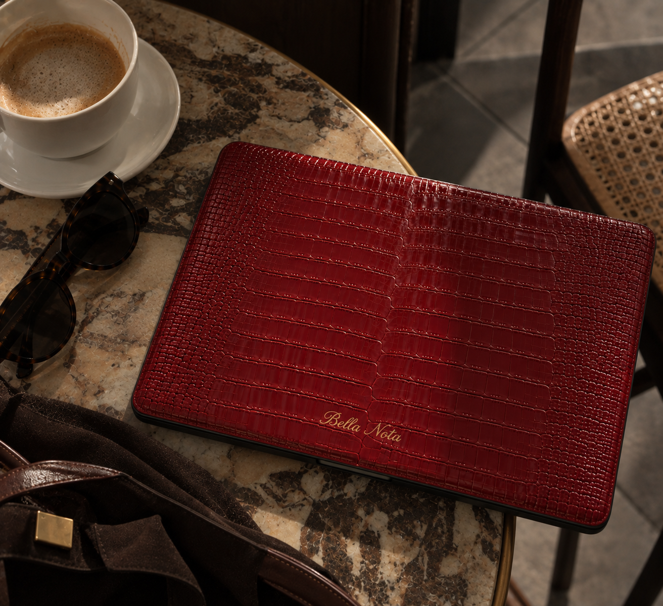 Rouge MacBook case styled at a café table